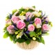Basket with pink roses and freesias, white scented