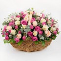 Basket with two dozen pink roses in a beautiful wicker basket.