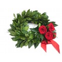 Wreath of laurel leaves with berries and red roses.