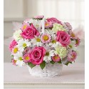 Compositions in basket with pink roses and daisies