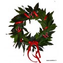 Wreath of laurel leaves with berries and red ribbon 